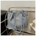 Detail of blue woven texture tote bag featuring silver chain strap and leather handle - Blue Without Charm