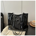 Close-up of black glossy crinkle tote bag with a silver metal bow buckle and chain strap - Black Without Pendant