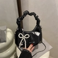 Black glossy crescent handbag with pearl bow pendant and chain strap detail - With Pendant / Black