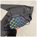 Detailed close-up of blue handbag with colorful checkered textured fabric and slim strap - Colorful