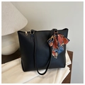 Detail of black leather tote bag with a colorful chain pattern silk scarf on handle - Black