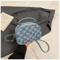 Close-up of light blue denim plaid crossbody bag with frayed edges and PU strap held by hand - Light Blue
