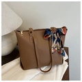 Detailed view of a brown faux leather tote bag with decorative floral silk scarf handle - Tan