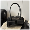 Detail of glossy black handbag featuring double front flap pockets and silver hardware - Black