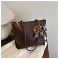 Deep brown tote bag detail featuring golden zipper and decorative silk scarf on the handle - Dark Brown