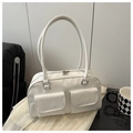 Detail shot of a minimalist white Boston tote bag with dual front flap pockets on fabric - White