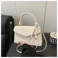 Detail of cream white handbag featuring marble texture leather and unique knot handle design - Large / White