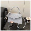 Detailed view of the wrinkled texture PU leather and knotted handle on a grey handbag - Large / Blue