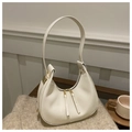 Minimalist beige leather crescent moon shoulder bag with gold double zippers and hardware - White
