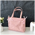 Detail view of pink bow tote bag with a clear PVC window and cross ribbon decor - Pink
