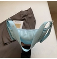 Close-up of light blue oil wax leather crossbody bag with silver eyelets and pleats - Light Blue