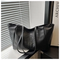 Detalle del bolso tote de cuero PU negro con logotipo circular cosido y correas finas - Negro