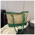 Detail of green leather stitching and woven straw texture on a large tote bag - Green