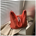 Detail of orange canvas hobo bag with wide shoulder strap and woven fashion zipper pull - Orange