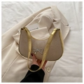 Beige woven crescent shoulder bag with golden metallic trim and silver bow detail - Gold