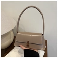 Detail view of khaki PU leather handbag with vintage bronze clasp and firm handle - Khaki