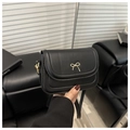 Detail of black matte leather shoulder bag featuring a gold bow metal clasp and strap - Black