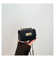 Detailed shot of black V-quilted small square bag with golden square lock and chain strap - Black
