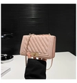 Close-up of quilted pink leather crossbody bag with gold metal chain and twist lock - Pink