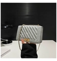 Detail of grey chevron quilted flap bag with golden chain strap and metallic lock clasp - Silver