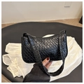 Minimalist black woven shoulder bag with intricate textured finish and top zipper closure - Black