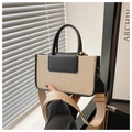 Chic beige canvas and black leather crossbody bag with wide strap and gold hardware - Black