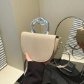 Beige woven saddle bag featuring a unique silver metallic handle and slim leather strap - Khaki