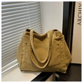 Detail of vintage mustard corduroy tote bag showing metal button pocket and fabric texture - Khaki