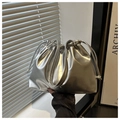Detail of silver metallic drawstring bucket bag featuring pleated texture and soft shape - Silver
