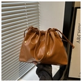 Detail of the brown drawstring tote bag with elegant pleats and shiny leather texture - Brown