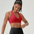 Deep red twist-front sports bra with cutout detail and black yoga leggings - Red