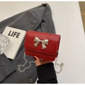 Mini red crossbody bag featuring a large silver bow and elegant chain strap - Burgundy
