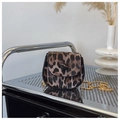 Detailed close-up of leopard print saddle bag with golden chain and button closure - Red Brown