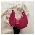 Close-up of bright pink crescent shoulder bag featuring smooth PU leather and metal buckle - Rose Pink