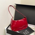Glossy deep red patent leather shoulder bag in a minimalist half-moon shape design - Red