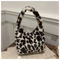 Close-up of soft leopard print faux fur texture on a stylish women's shoulder bag - White