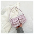 Detailed macro view of light purple corduroy texture and dual front flap pockets on the bag - Pink