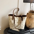Large beige and brown geometric print tote bag with leather handles on a display table - Style 1 White