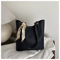 Detail of black leather tote bag with white contrast stitching and printed silk scarf accessory - Black