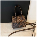 Detailed view of the leopard print PU leather handbag with gold-tone metal hardware - Brown