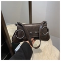 Detail view of vintage dark brown faux leather bag with silver metal rings and rivets - Coffee