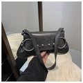 Detail of black baguette bag with large silver rings and punk style metal rivets - Black