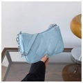 Close-up of light blue quilted shoulder bag with silver chain and metal zipper detail - Blue