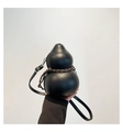 Detail van de kalebasvormige lederen tas met gevlochten touw en metalen ritssluiting - Zwart