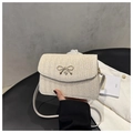 Chic cream woven crossbody bag featuring a delicate gold bow buckle and slim strap - White