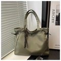 Detail of army green nylon tote bag with drawstring closure and woven rope charm - With Pendant / Green