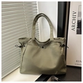 Detail of olive green nylon tote bag featuring black snap pocket and adjustable drawstring - No Pendant / Green