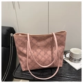Detailed view of pink tote bag with cherry blossom pattern on a black wooden side table - Pink