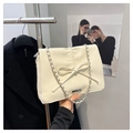 Cream-colored pleated leather shoulder bag featuring a stylish bow and chain strap - White