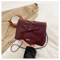 Burgundy bow shoulder bag with silver chain strap and textured leather finish - Red